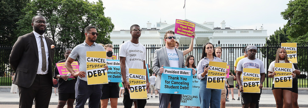 Group of people in front of White House with "Cancel Student Debt" signs